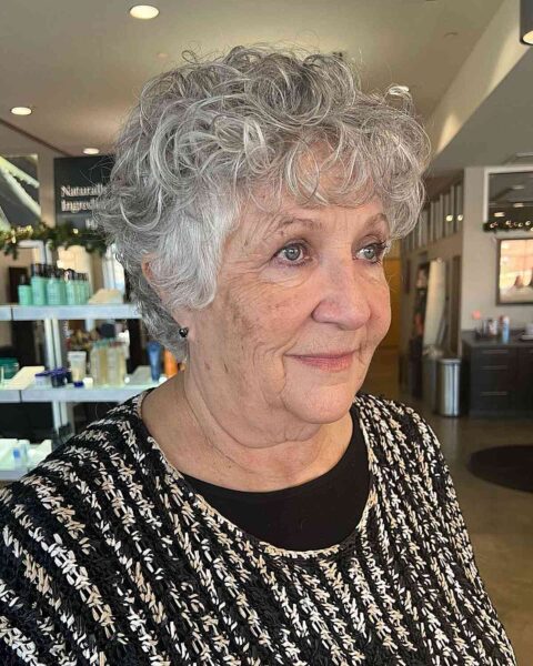 A Salt and Pepper Curly Long Pixie for Women Over 60 with thin hair