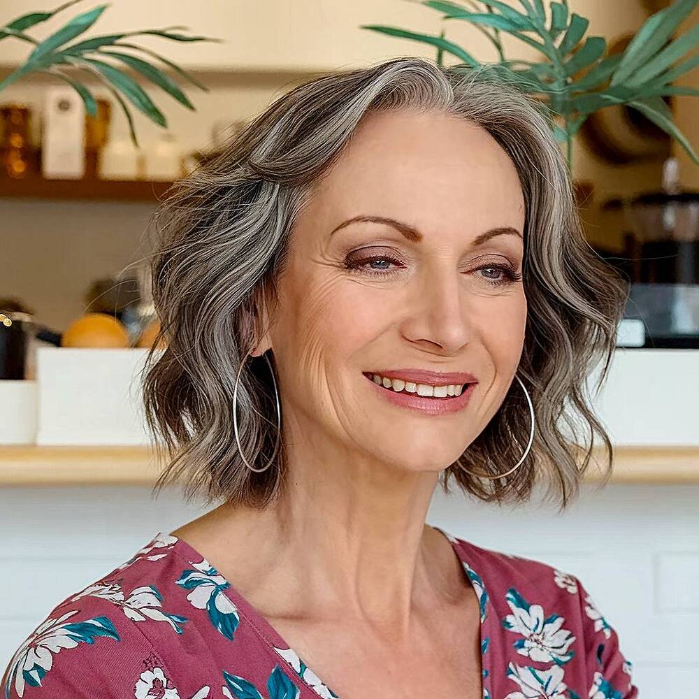 Salt and pepper layered haircut for dimension and movement, a stylish choice for women over 60