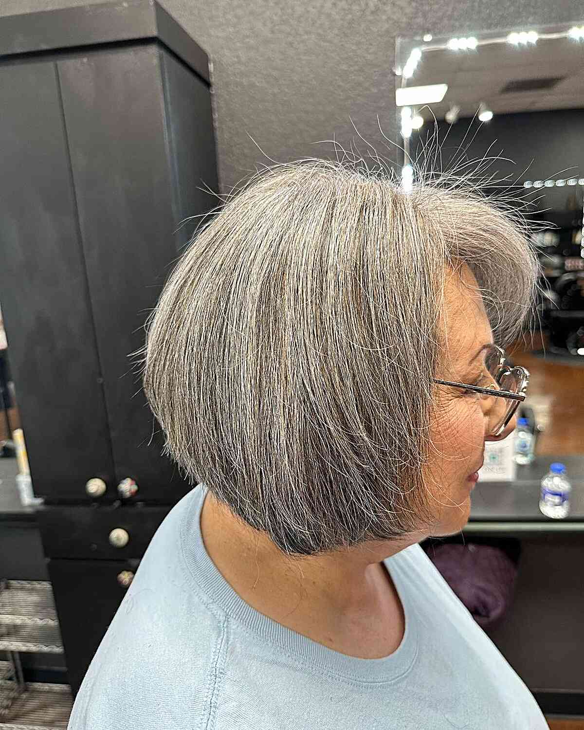 Salt-and-Pepper Short Chin-Length Haircut with Side Fringe on Seniors Aged 60 Wearing Glasses