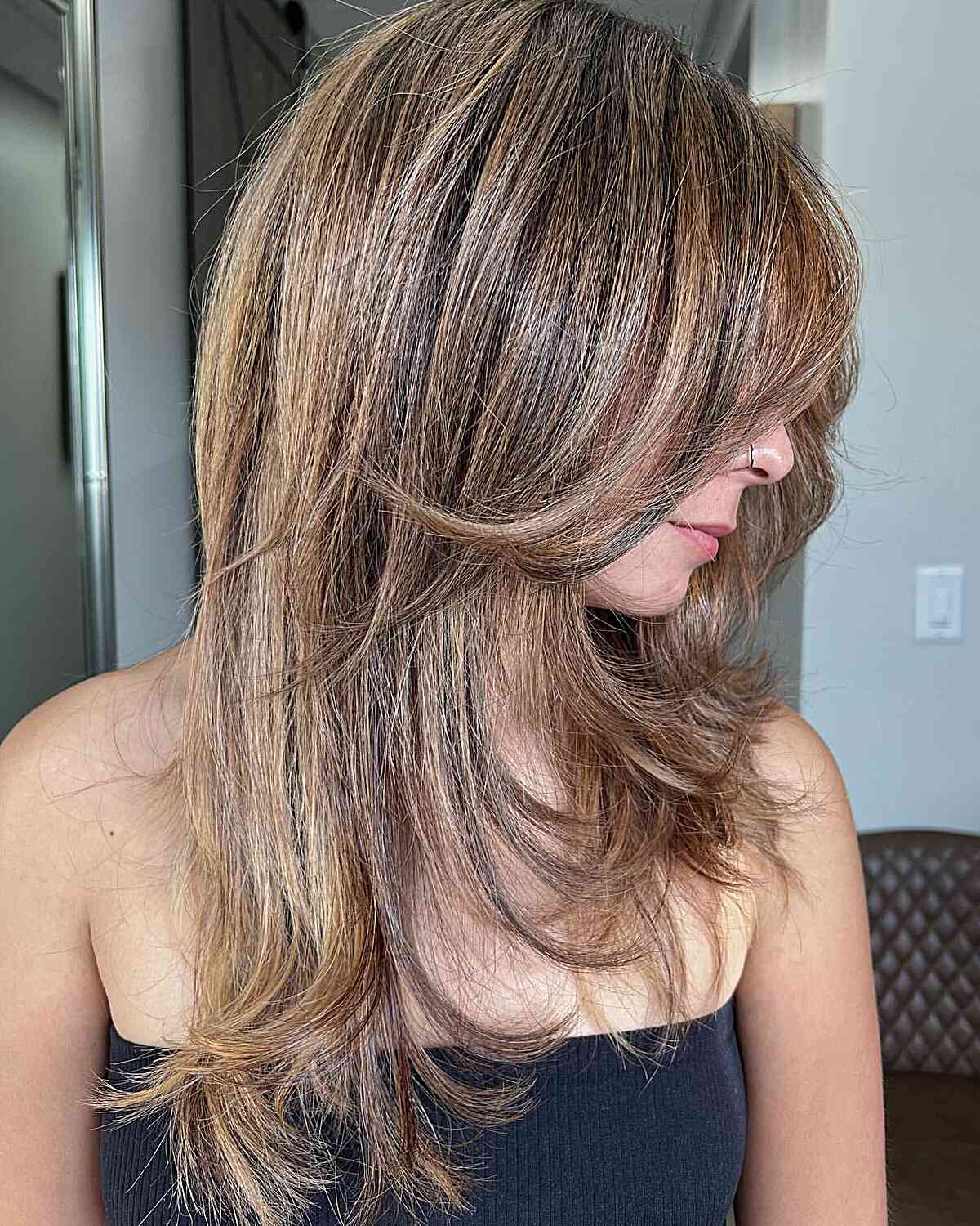 Sandy Bronde Balayage Hair with Medium-Long Layers and Flipped Ends