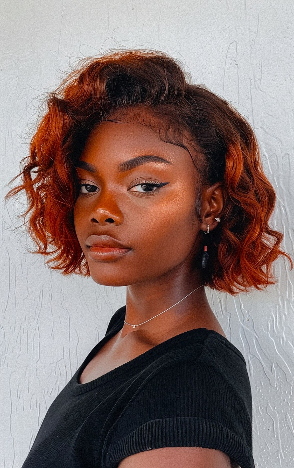 Bold chin-length hairstyle with loose waves and copper tones for Black women