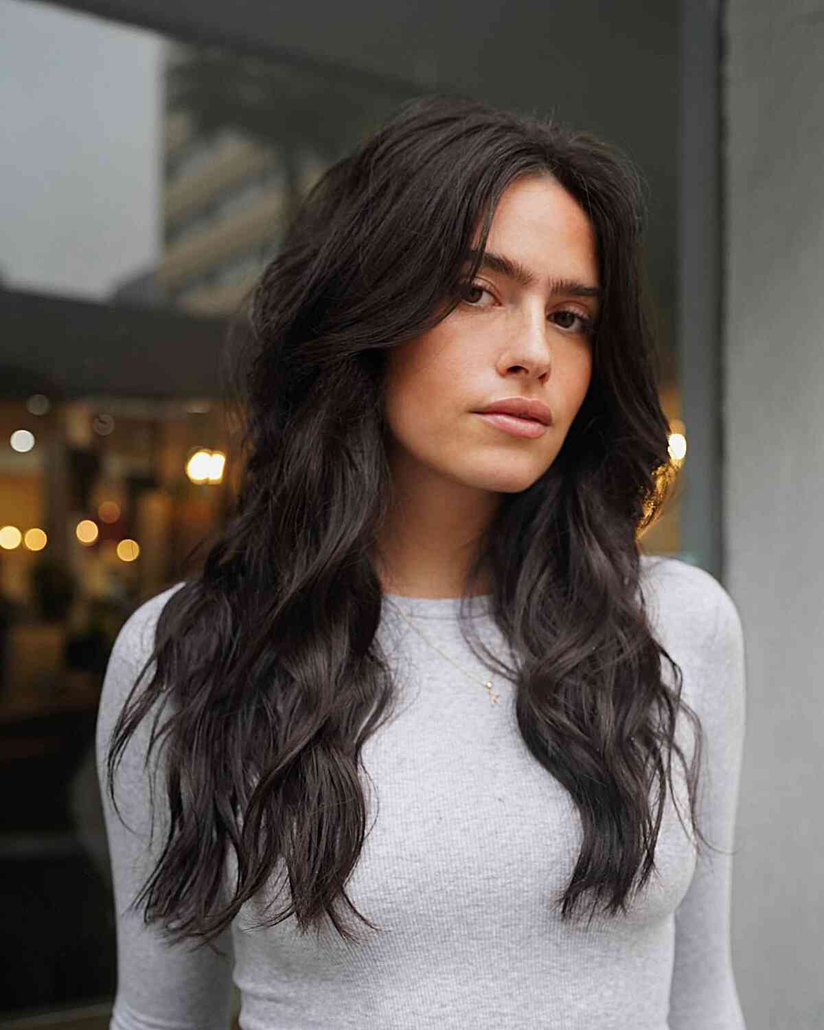 Sexy Long Layered Hair with Curtain Fringe on wavy tresses and a middle part