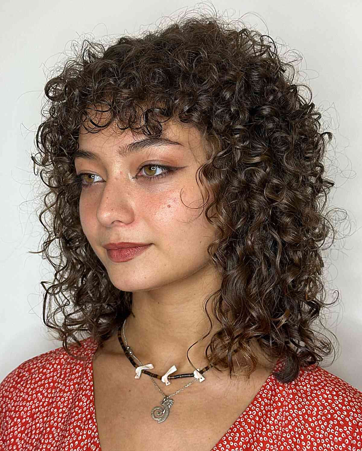 Shaggy Curly Lob with Bangs for women with shoulder-length hair
