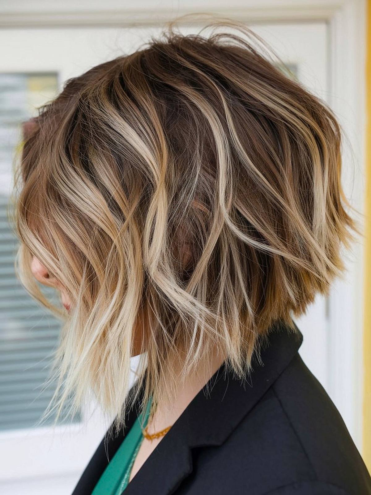 Shaggy layered inverted bob hairstyle with blonde highlights