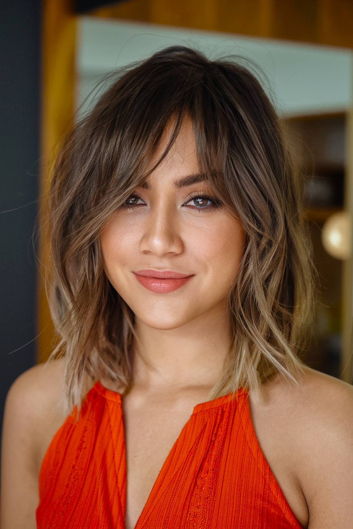 Shaggy lob with curtain bangs, featuring layered movement and soft waves for fine hair