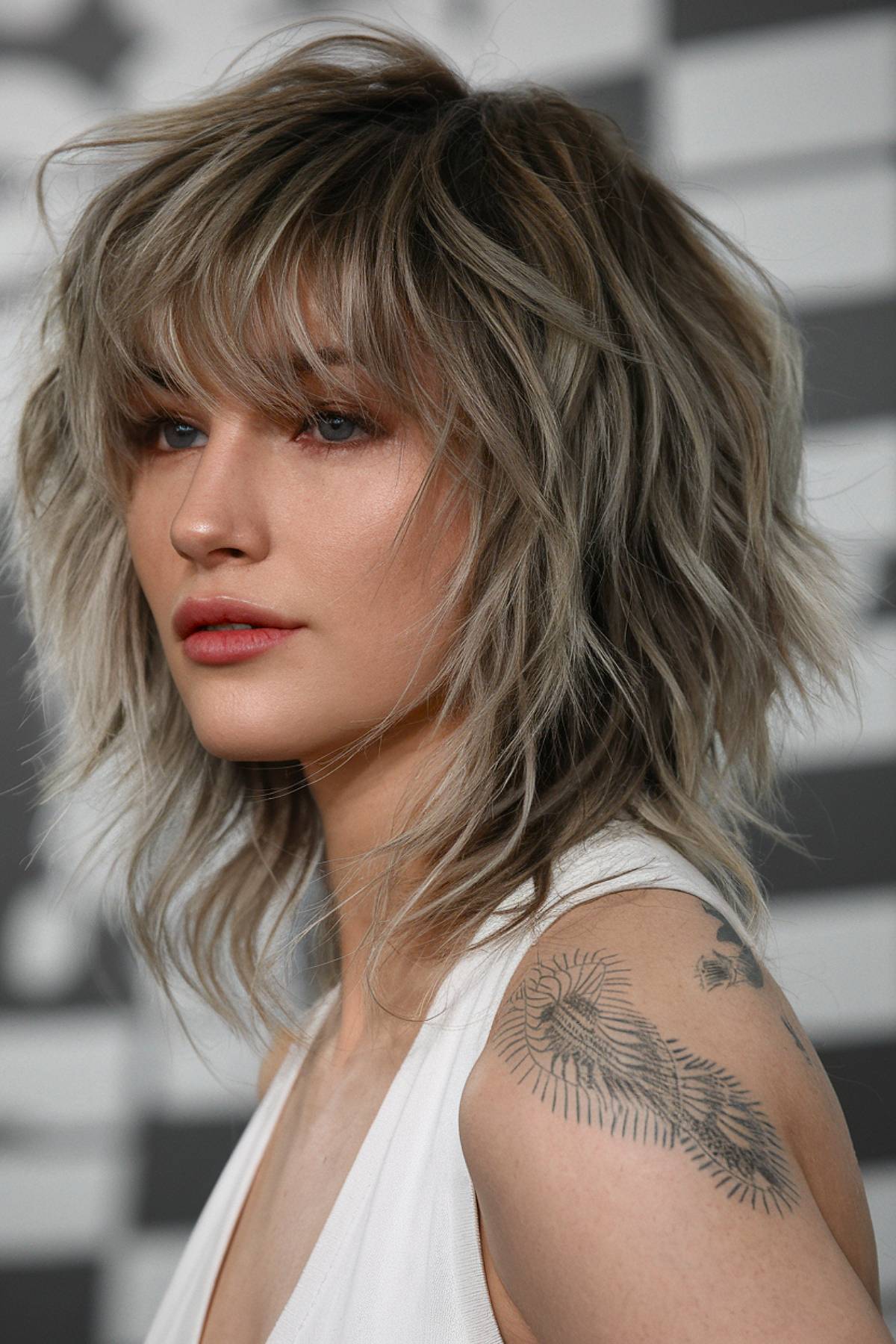 Shagullet haircut with layered shaggy texture and soft bangs for a modern, lived-in look