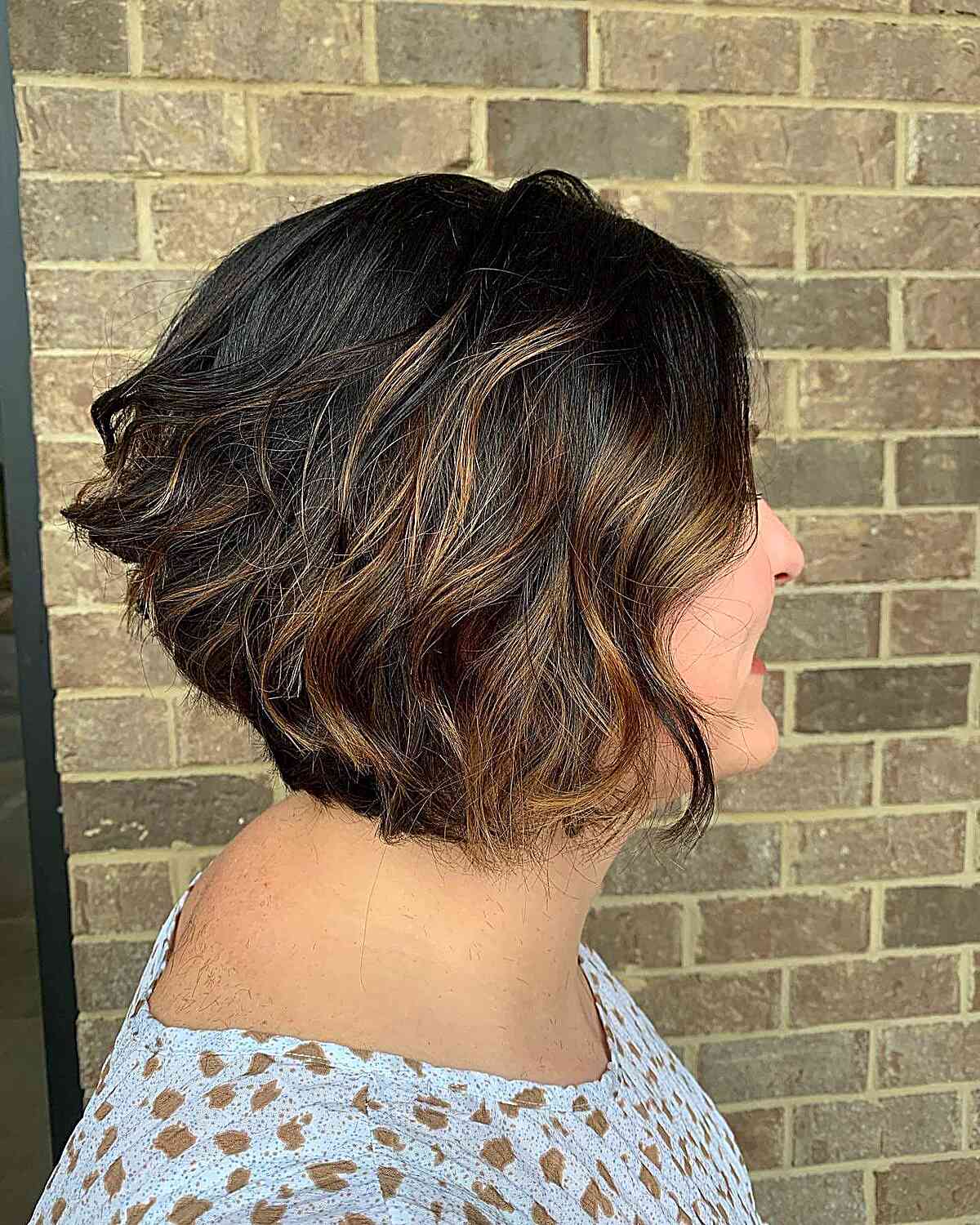 Short A-Line Dark Hair with Caramel Highlights and Textured Waves