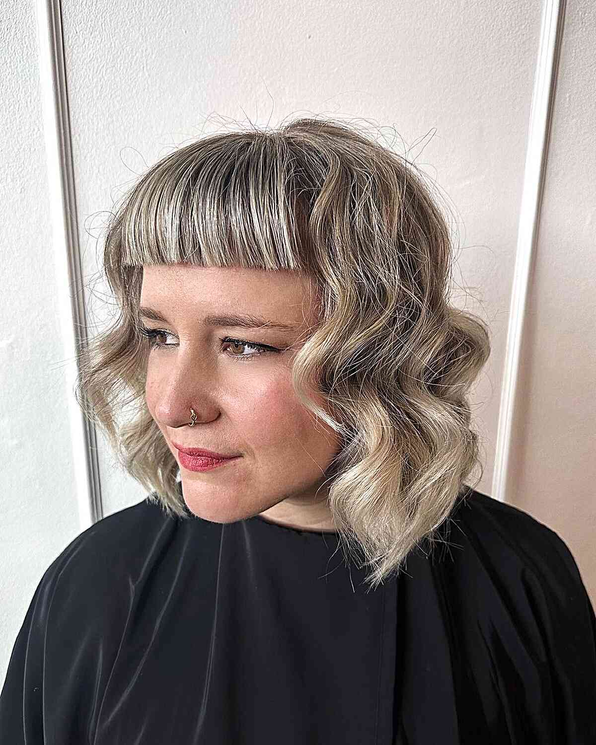 Short and Thick Straight Bangs for women with balayage and bablights in their hair