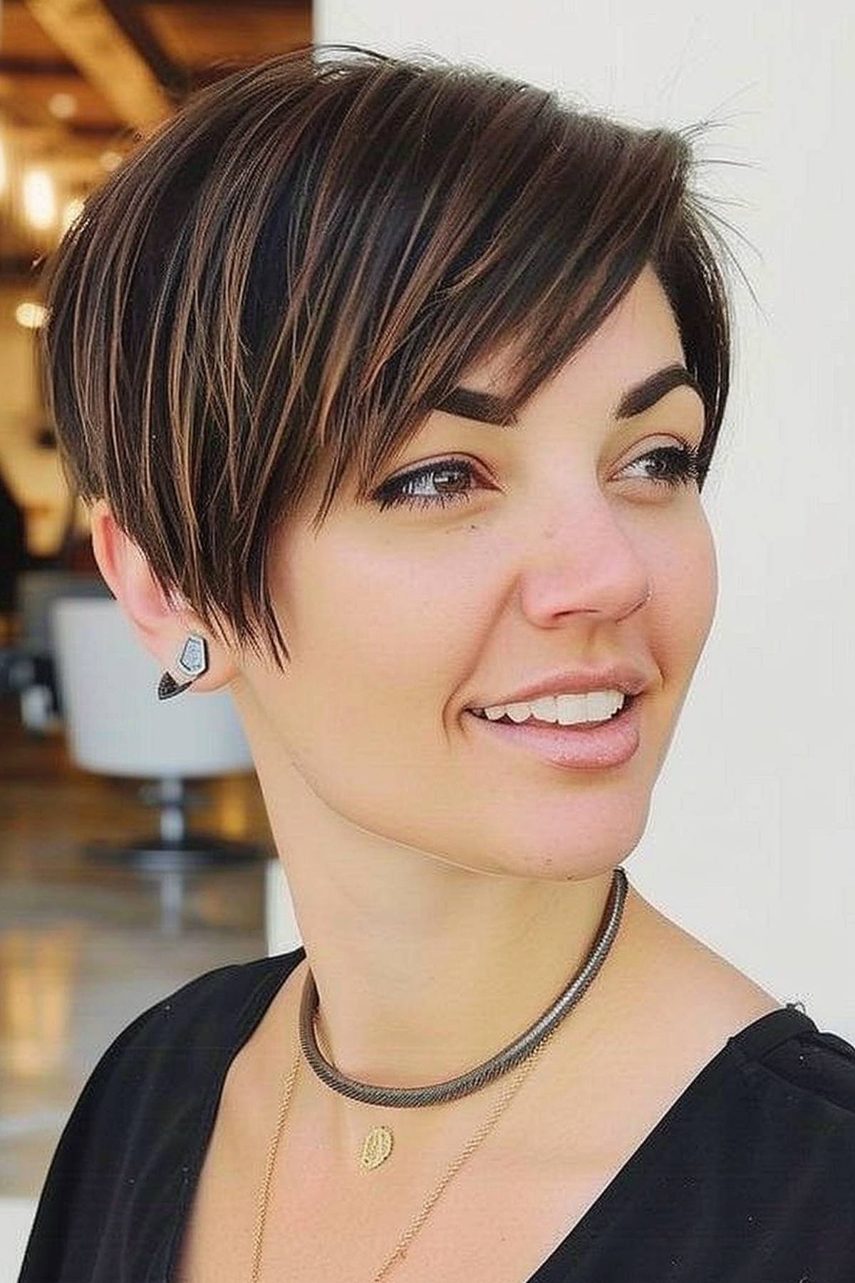 A woman with a short, angled bob hairstyle that combines the sharpness of a pixie cut with the elegance of a bob.