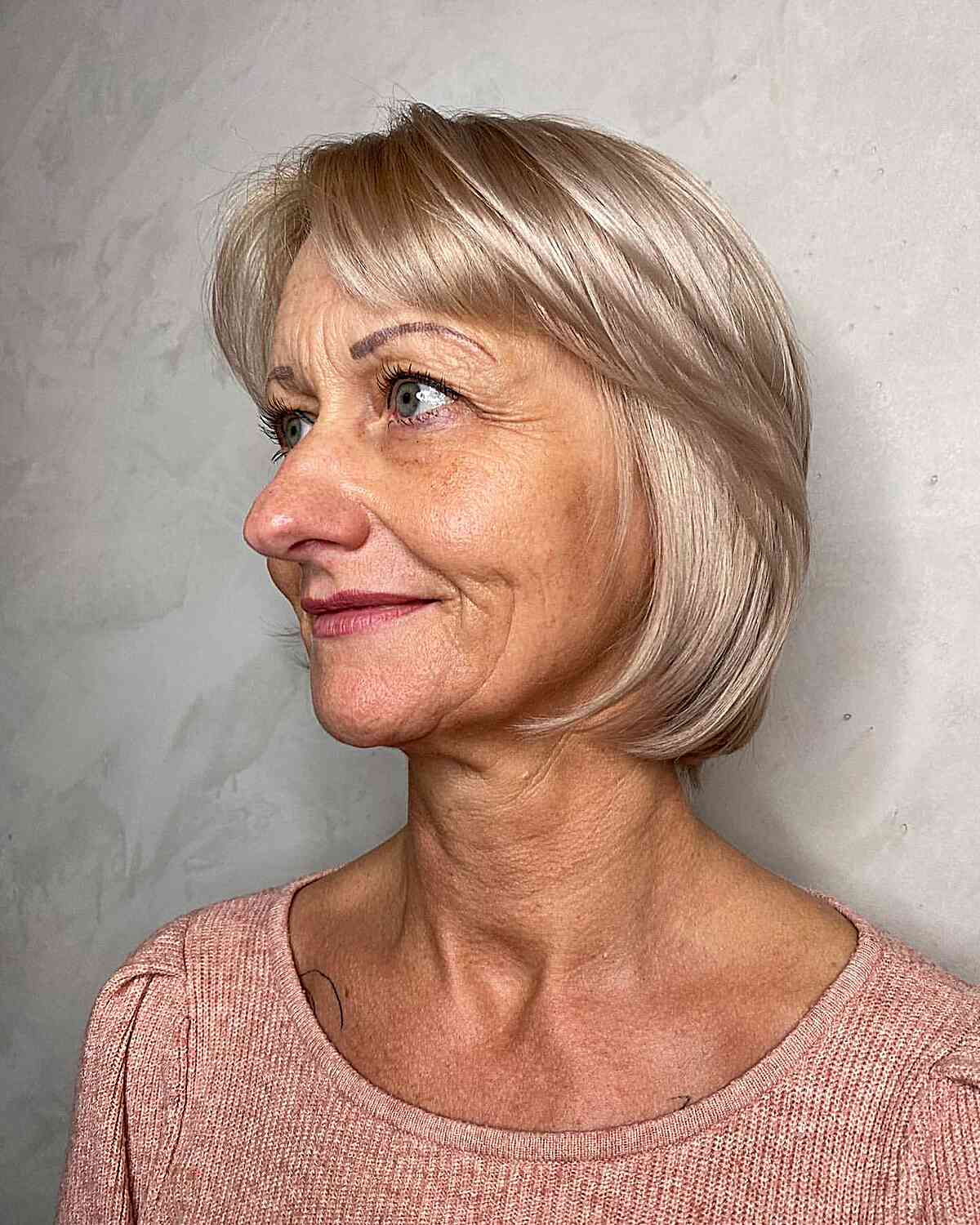 Short Ash Blonde Bob with Curtain Bangs for Ladies Aged 70
