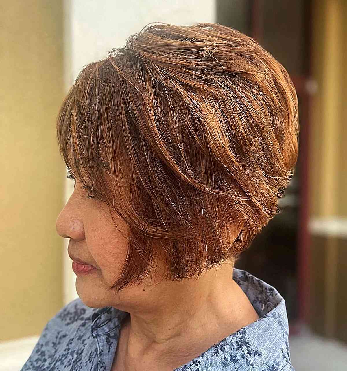 Short Auburn Bob with Stacked Layers and Bangs for Ladies Over 60