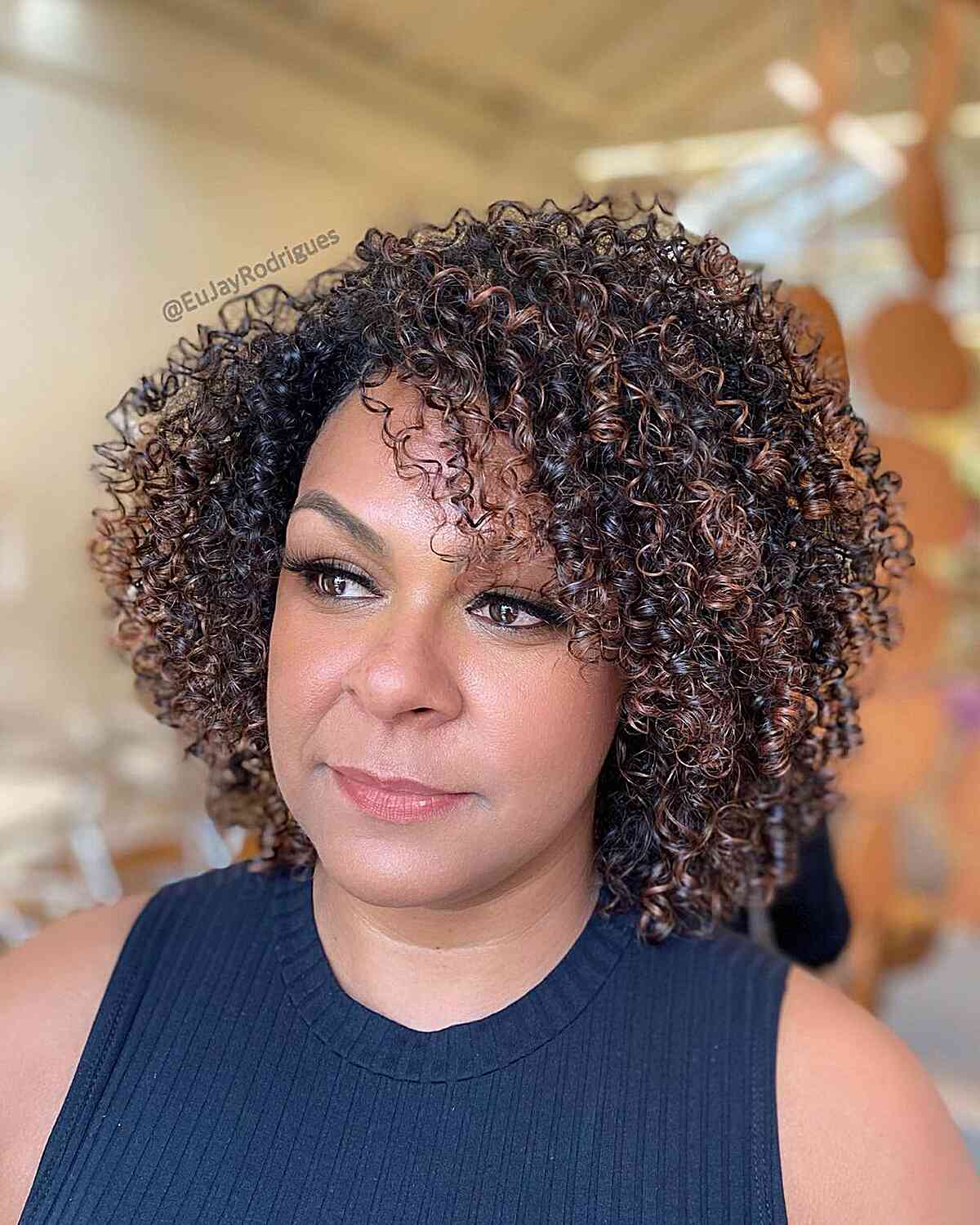Short Black Curly Hair with Caramel Balayage Highlights