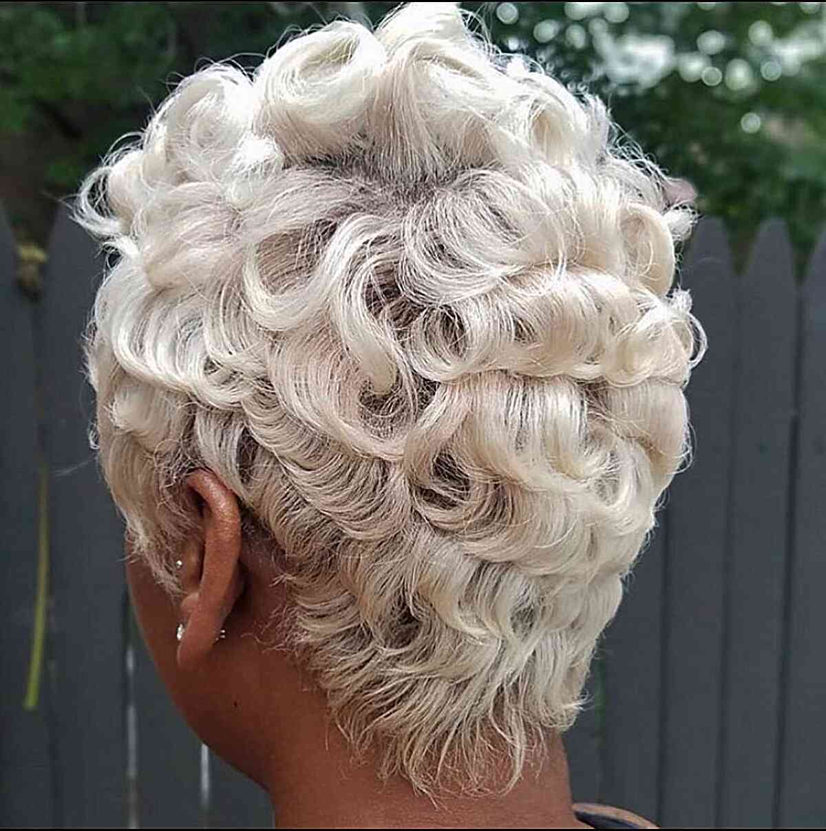 Black woman with a short pin curl hairstyle