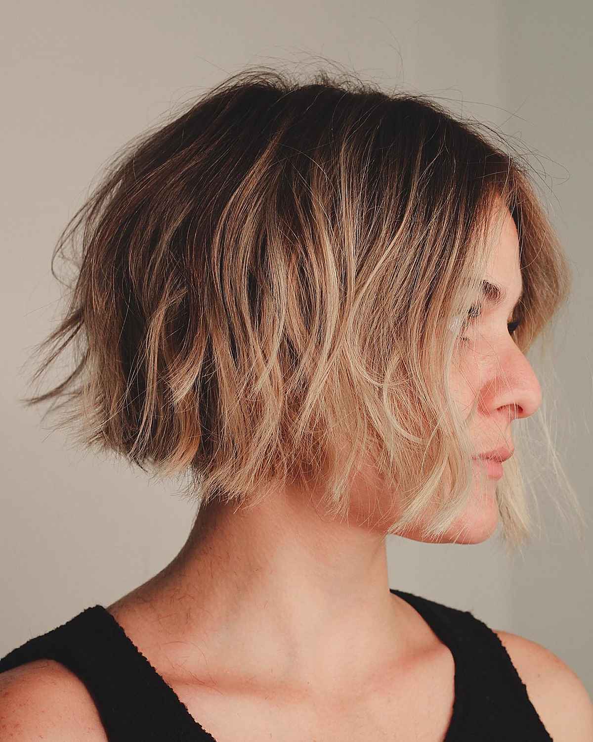 short blunt cut with sandy blonde hair coloring