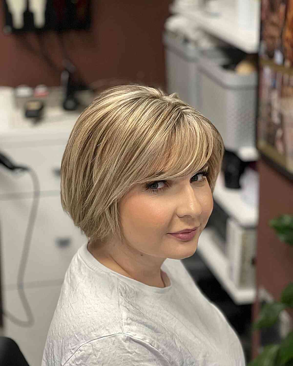 Short Bob Cut with Swoopy Bangs for Fuller Face Shapes