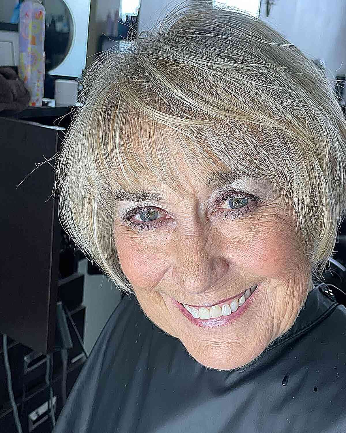 Short Bob with Bangs and Soft Blonde Tones for 60-year-olds