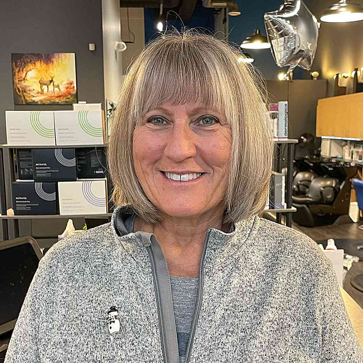 Short Bobbed Gray Hair with Full Bangs on Round Faced 60-year-old Ladies