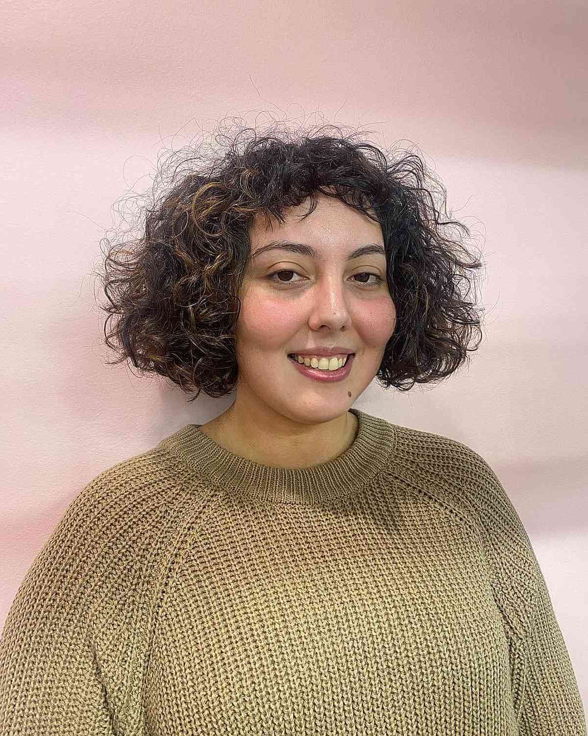 Short chin length choppy hair with frizzy curls and micro bangs