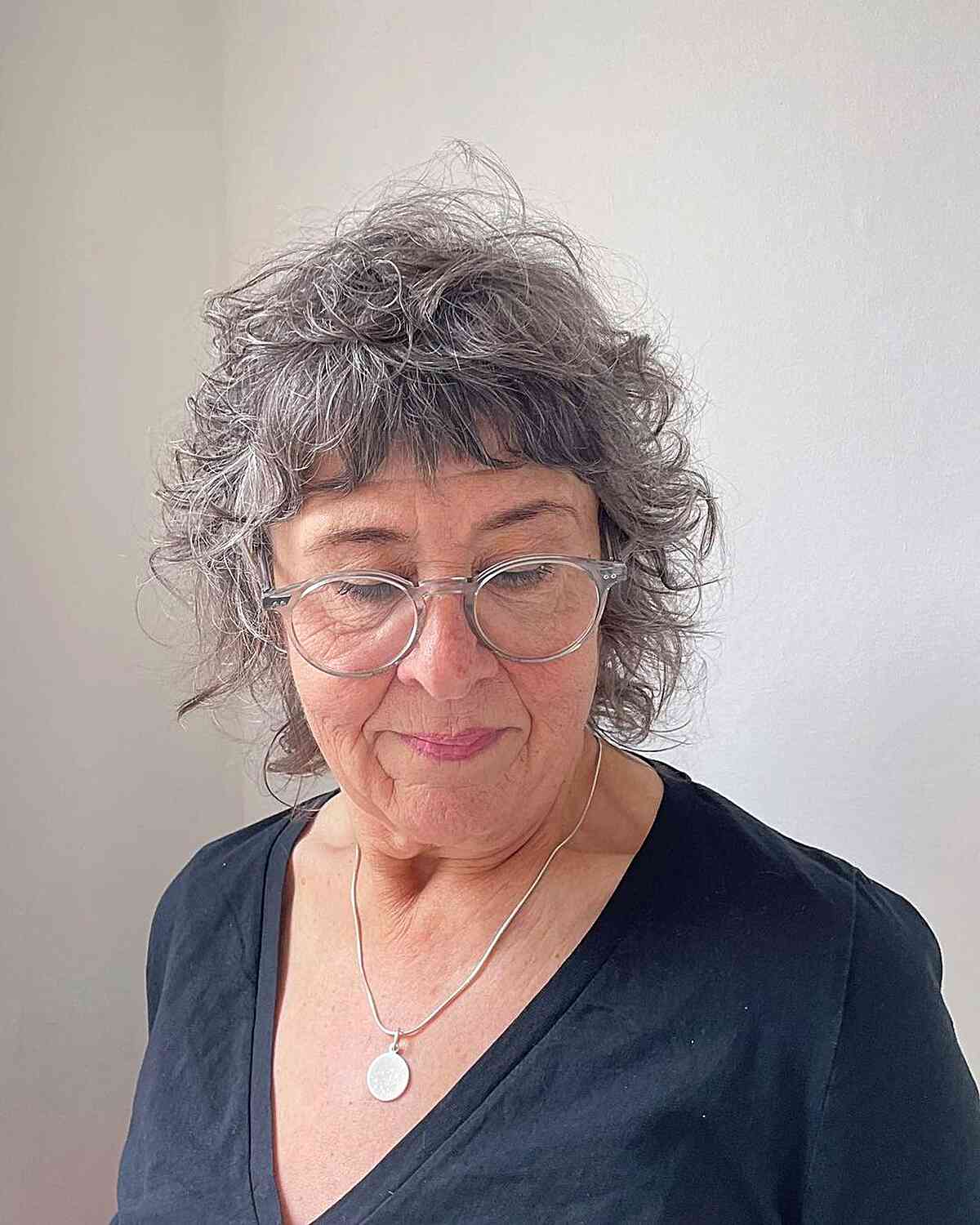 Short Chin-Length Textured Shag with Mini Bangs for Grey-Haired Woman Over 60