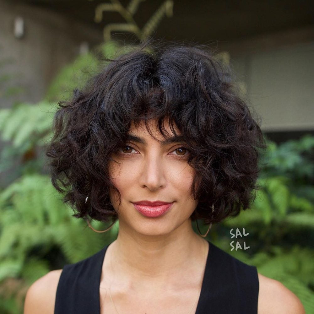 Short Curly Hair with Brow-Skimming Bangs