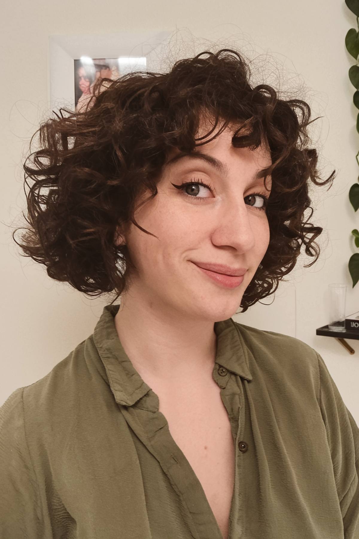 short curly haircut with bangs for women