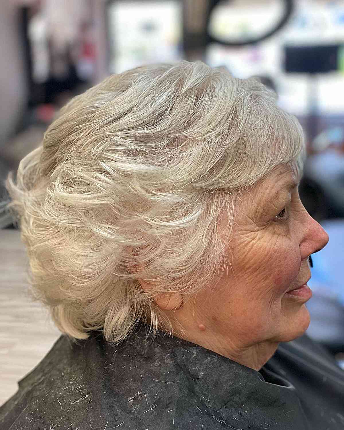 Short Feathered Cut with Mini Side-Swept Bangs on Older Women with White Hair
