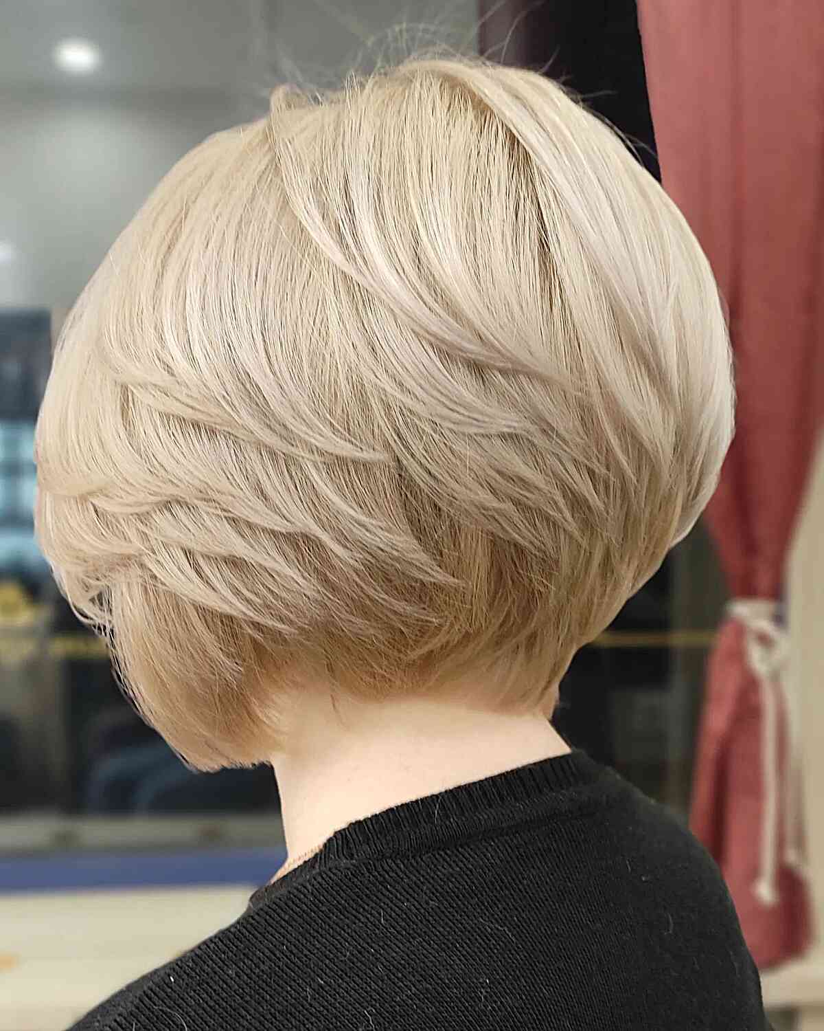 Straight Short Feathered Bob Cut with layers on blonde hair cut at the nape