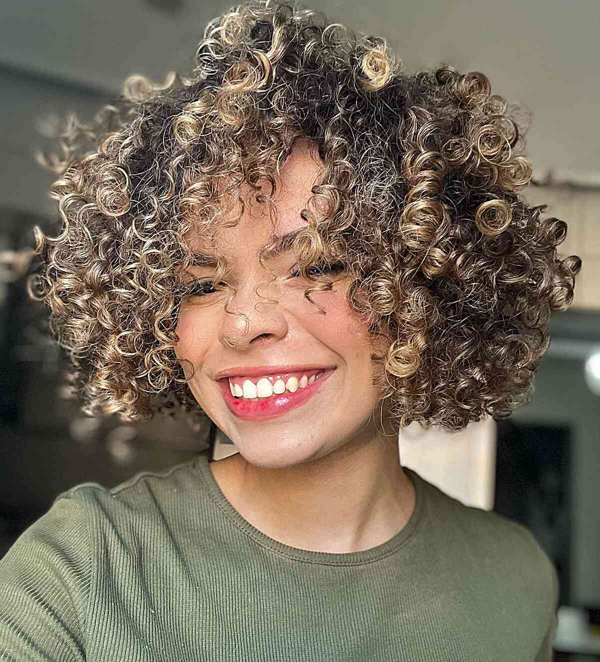 Short Frizzy Curls with Blonde Highlights for girls with thick curly hair