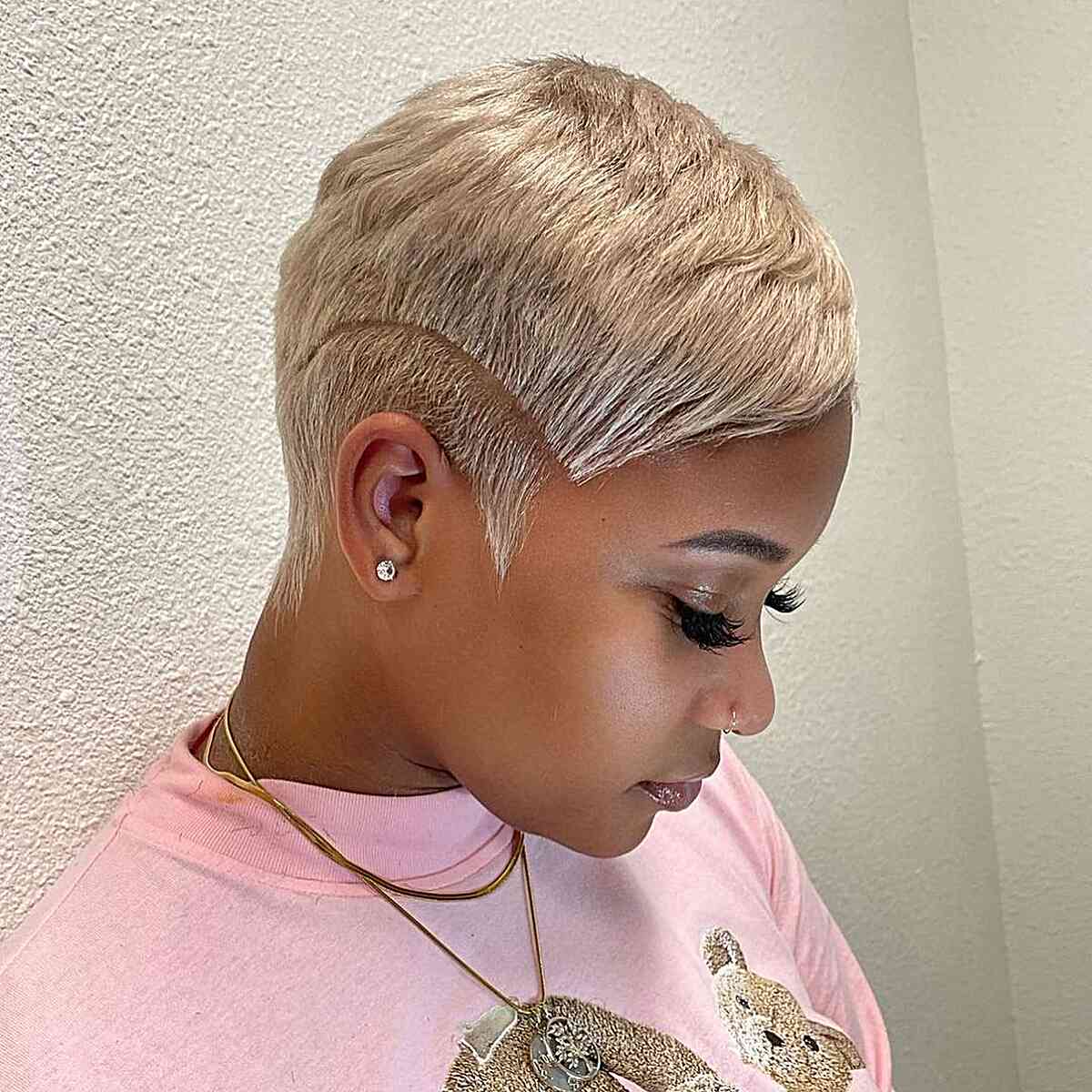 A women with short gold pixie haircut