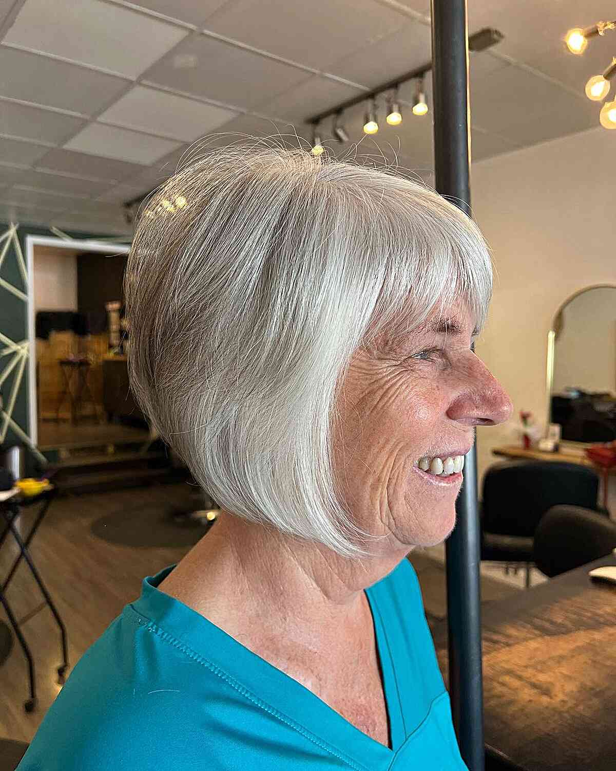 Short-Length Grey Inverted Bob with Wispy Layers and Bangs for Ladies Over 70