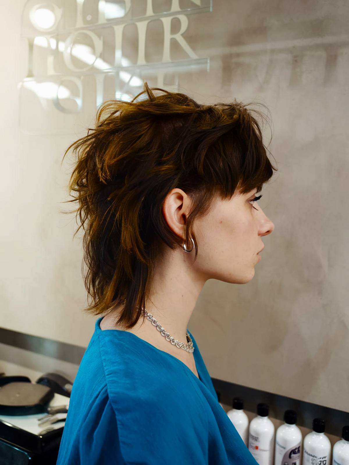 Short grunge mullet with messy layers and tousled, uneven texture for a rebellious look