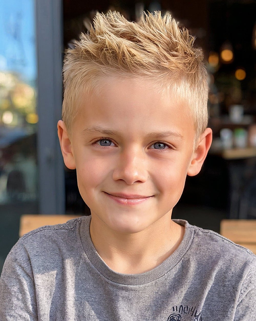 Boys short spiky haircut with textured layers and light fade