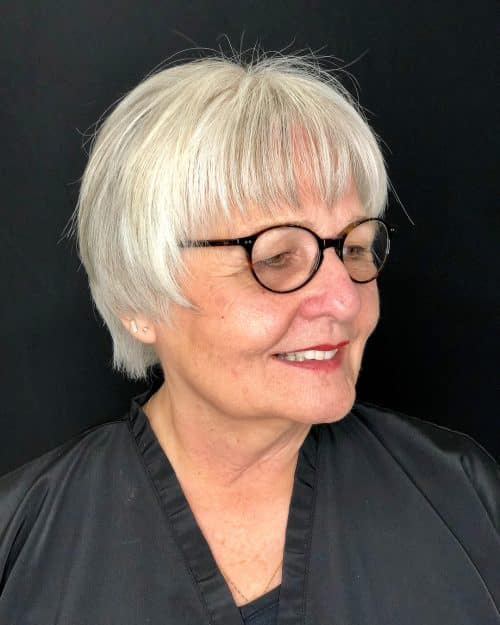 short hairstyle for over 50 with glasses and a round face