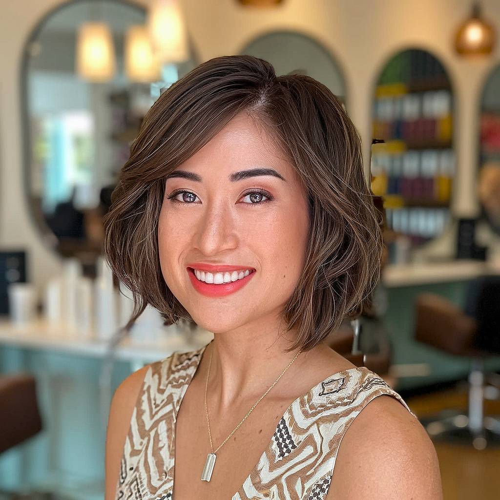 Chin-length short hair with layers and side-swept bangs for added movement