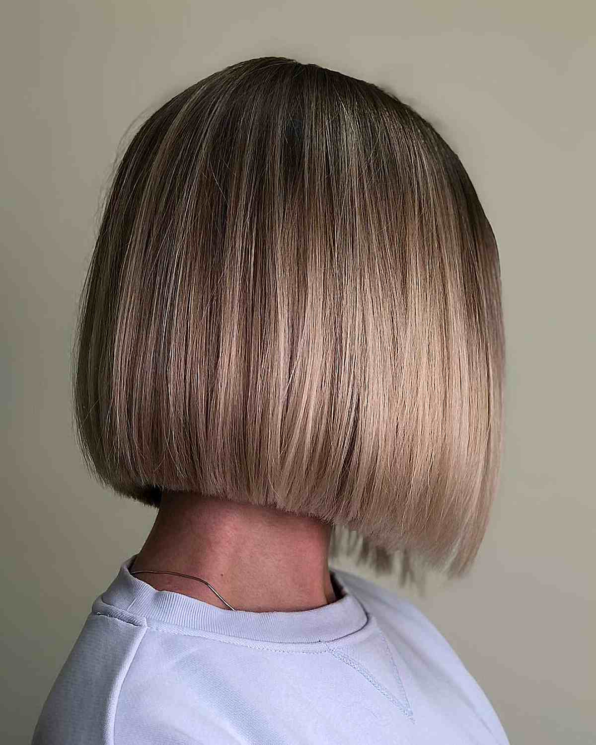 Short Neck-Length Blunt Bob with Dark-Rooted Blonde Balayage