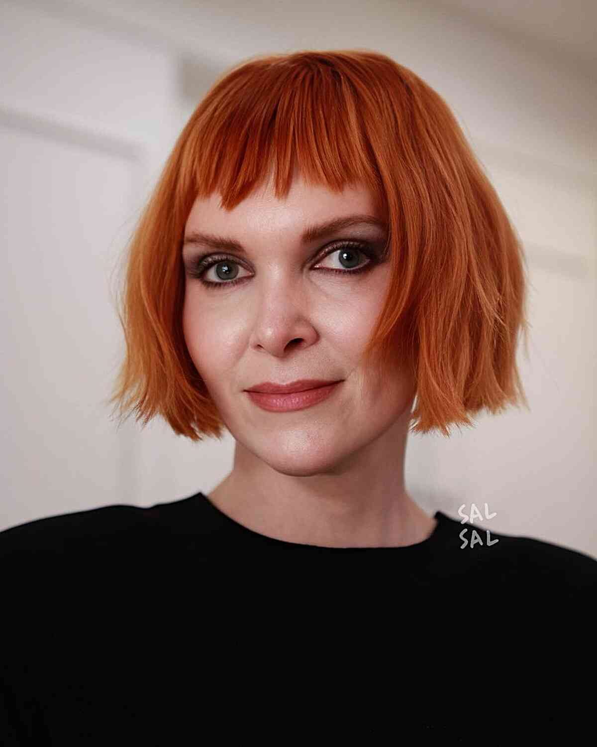 Short Orange Bob with Short Bangs for women with an edgy style