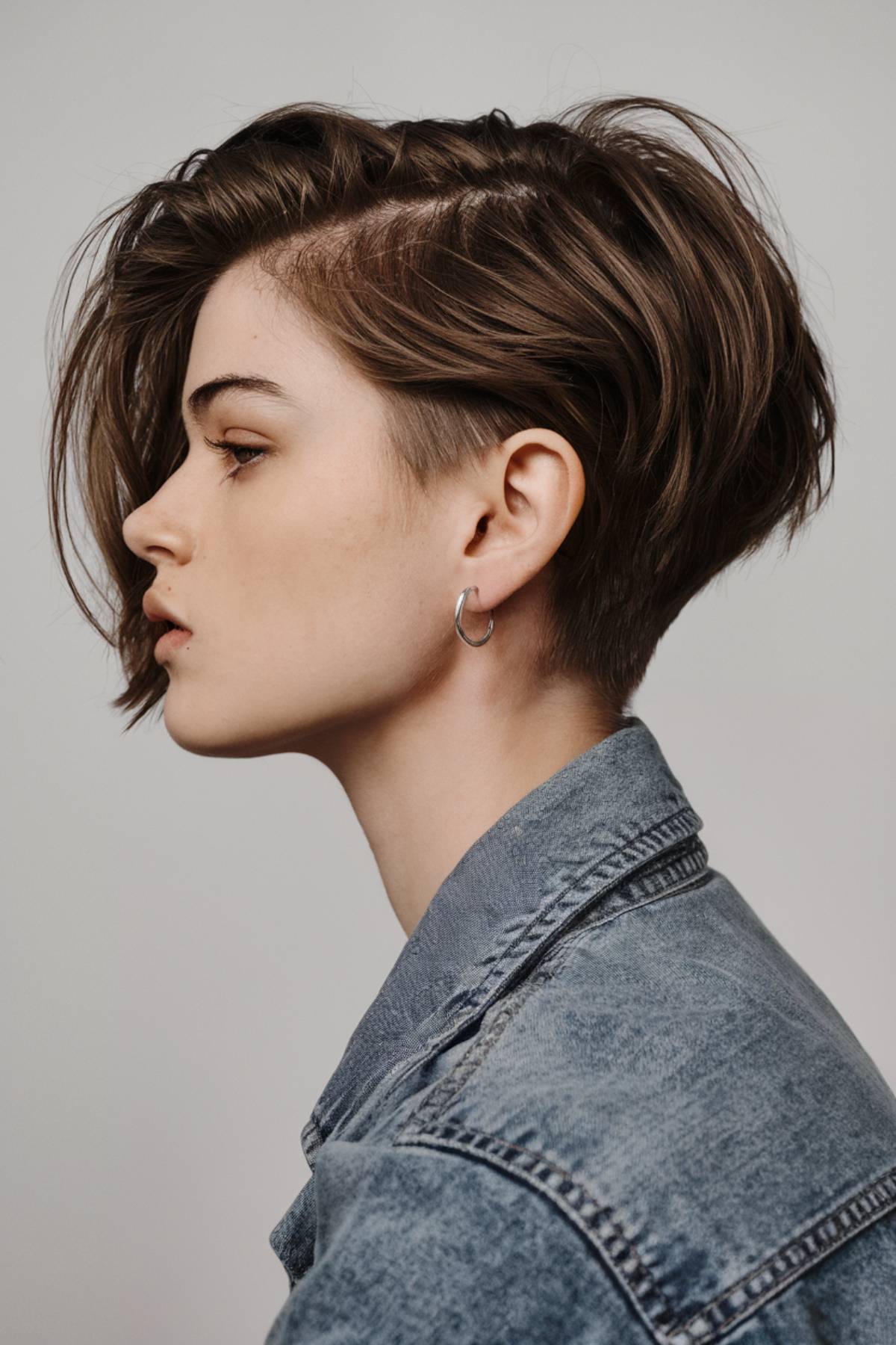 Edgy short pixie bob with an undercut, creating a bold contrast and easy maintenance