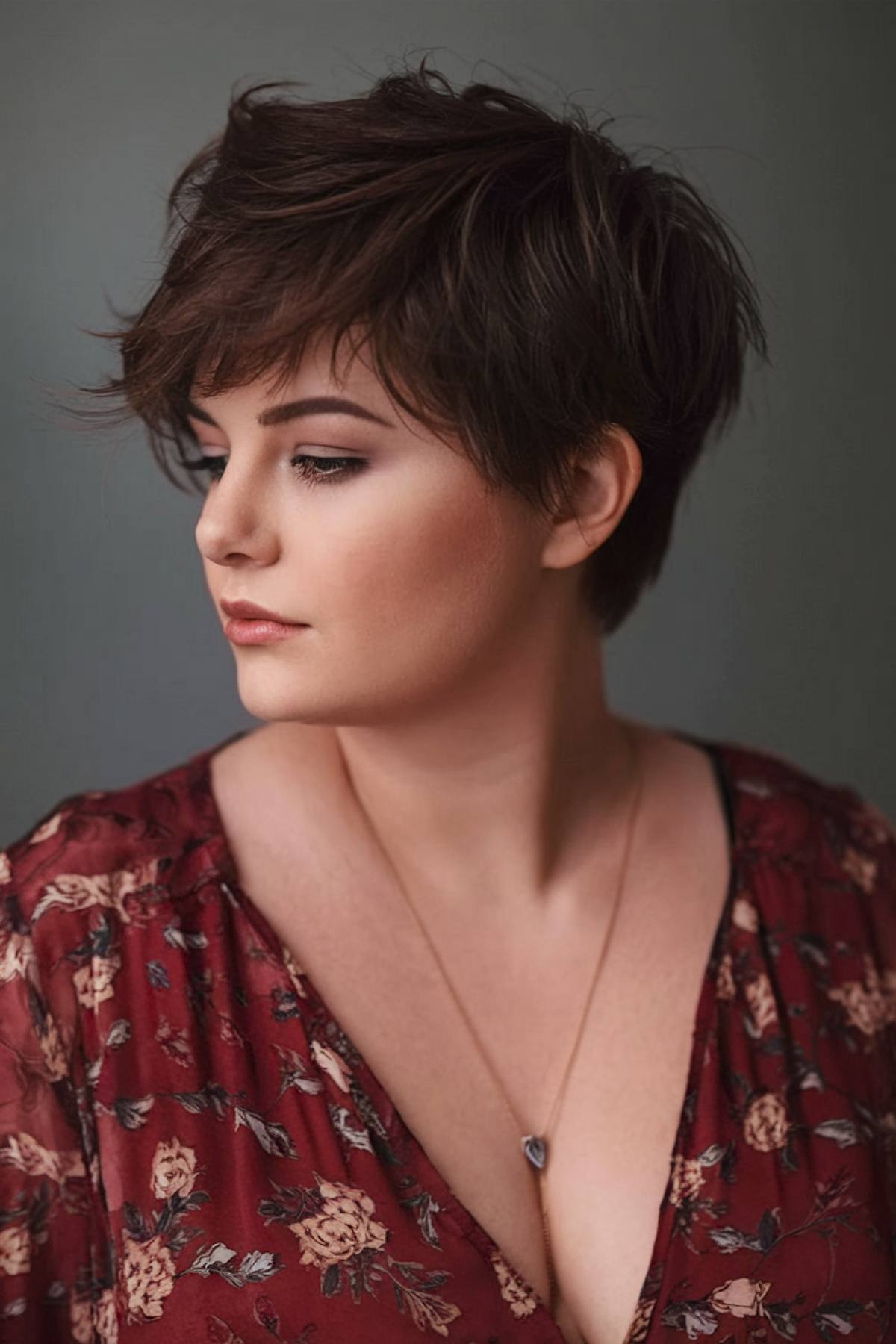 Short pixie style for plus size women with side-swept layers