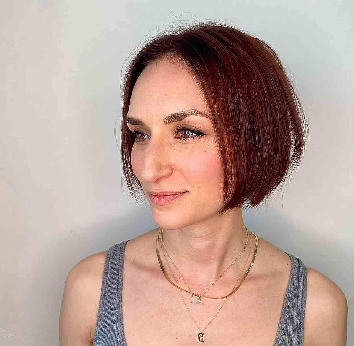 Bold Short Red Bob with Angled Layers for Thin-Haired Women