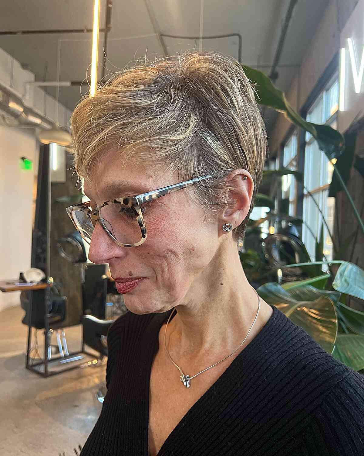 Short Side-Swept Pixie with Blonde Highlights for women past their 60s with glasses