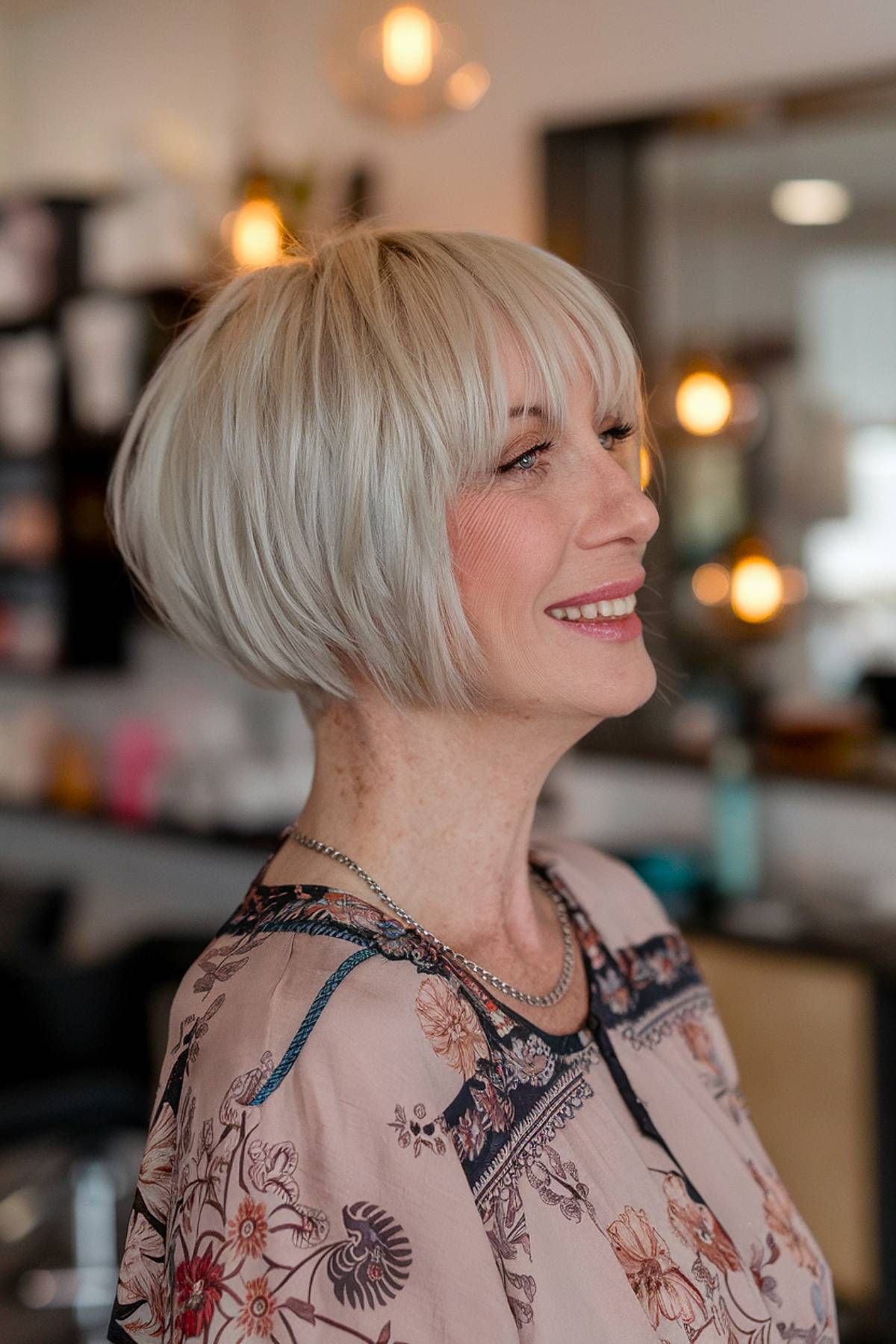 A short stacked bob with bangs, featuring stacked layers in the back for extra volume and shape