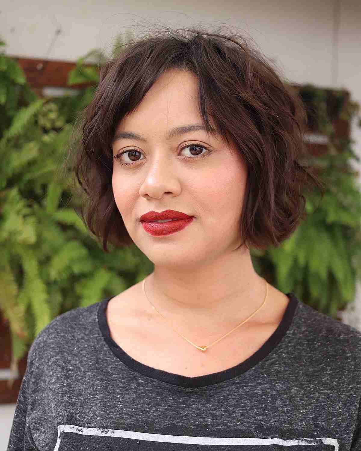 Short Textured Wavy Bob Cut with a Side Part and Bangs