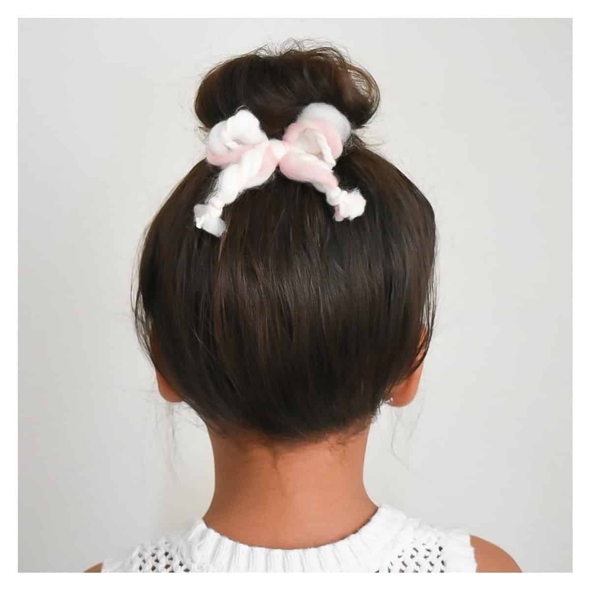 Short top knot style for a toddler