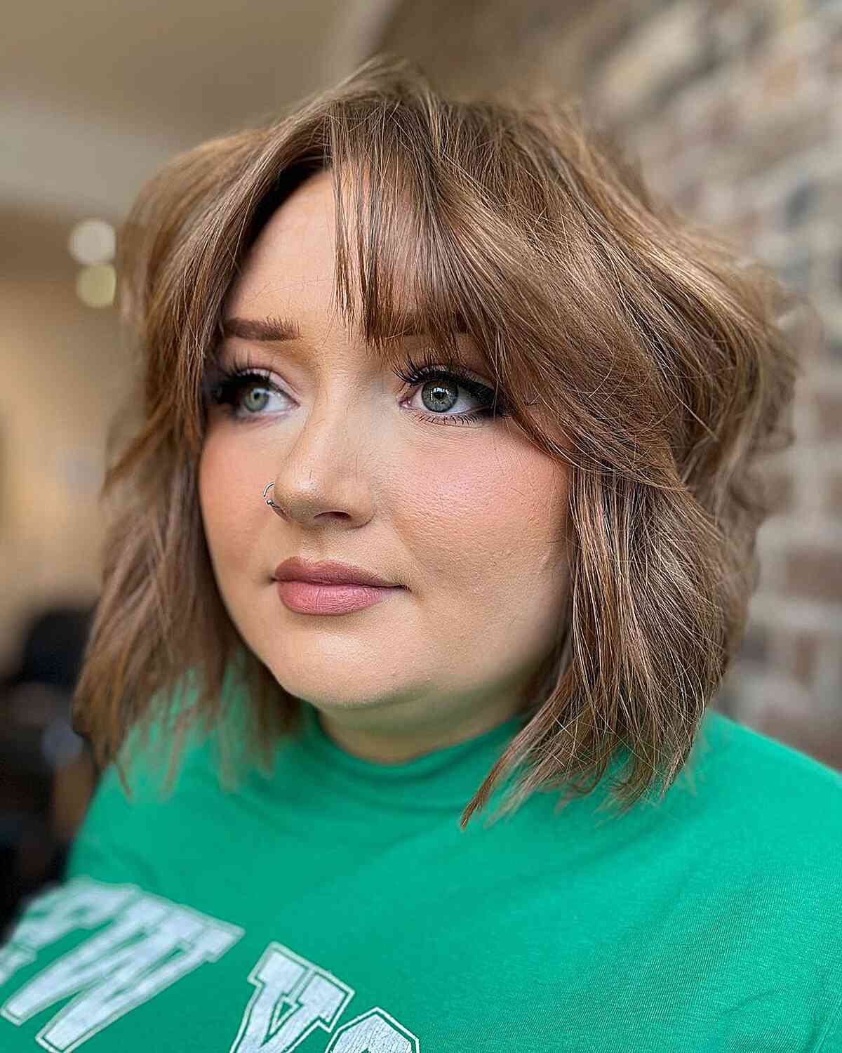 Short Voluminous Textured Bob with Curtain Bangs on Women with Rounder Face Shapes
