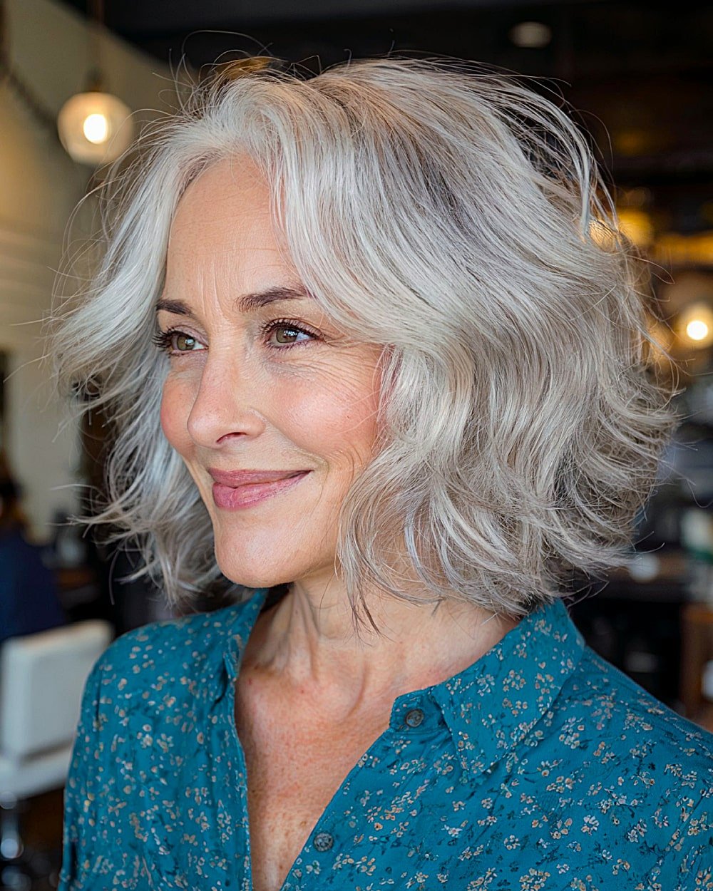 Short wavy bob with grey layers for women over 60, soft face-framing style with natural volume