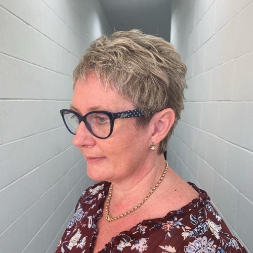 Messy Shorter Cut for Fine Hair on a woman over 50 with blue frames