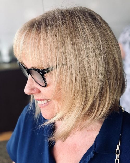 Sophisticated Shoulder-Length Angled Bob for 50 year old women with black frames