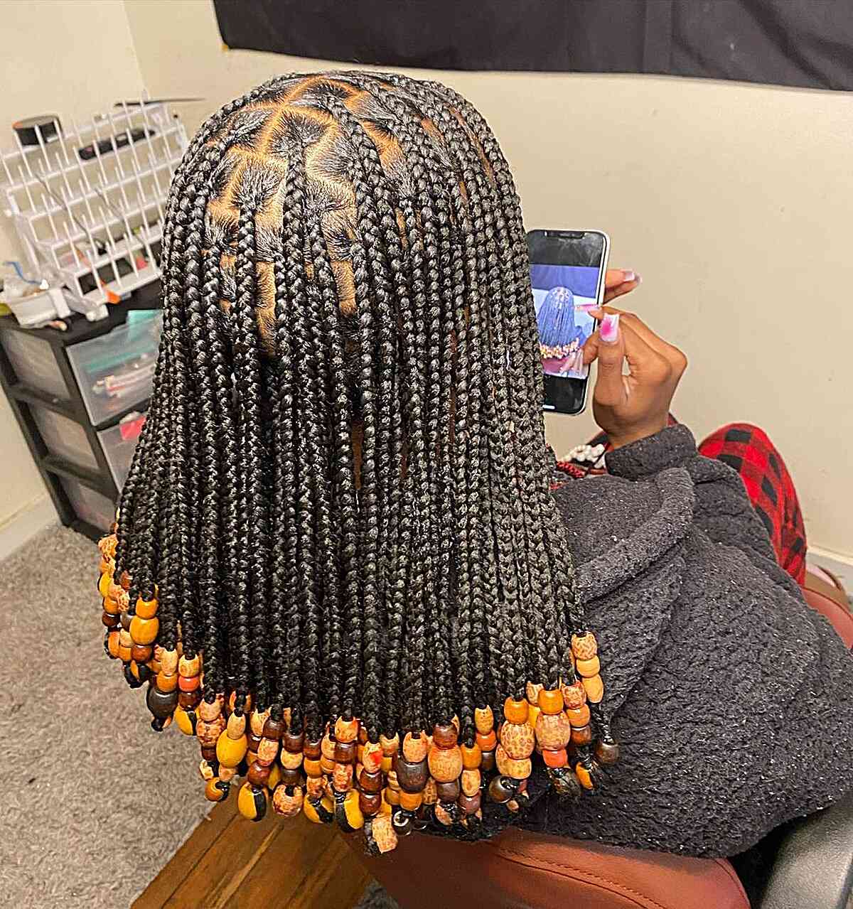 Shoulder-Length Black Knotless Braids with Orange Beads for Thick Hair