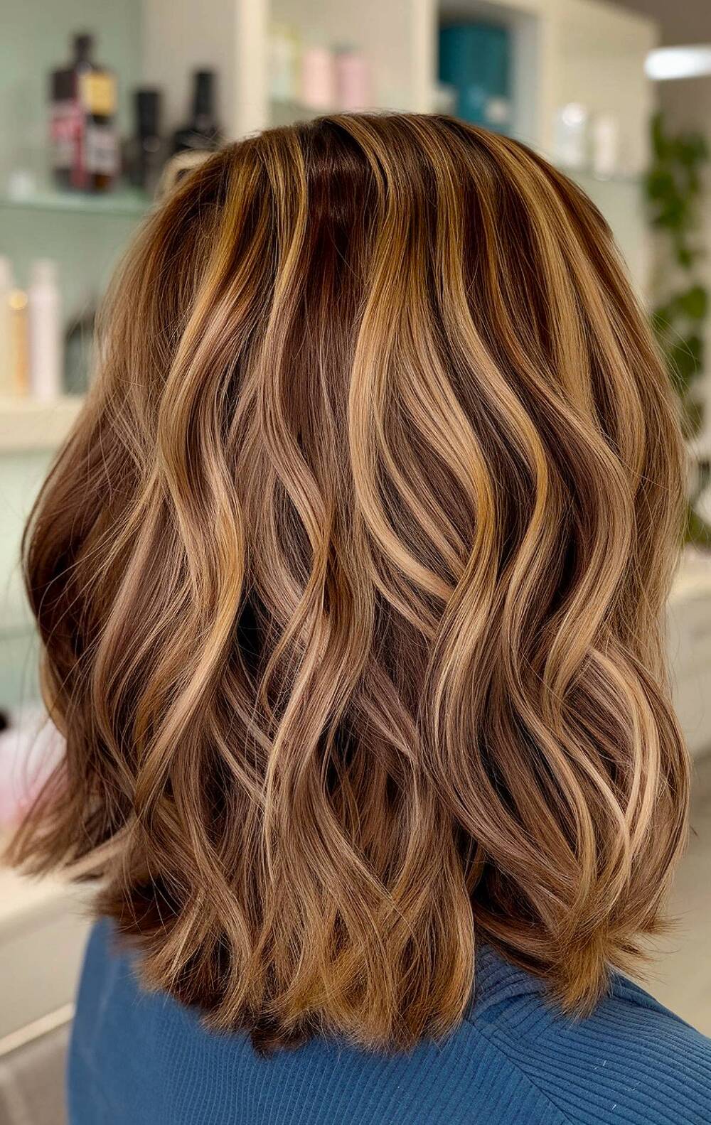 Warm brown shoulder-length hair with blended blonde highlights for dimension and brightness