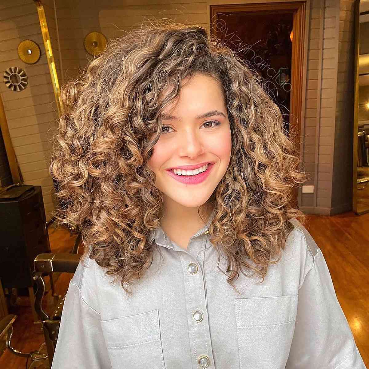 shoulder-length curly locks with side bangs